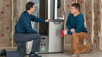 Two men working on a furnace